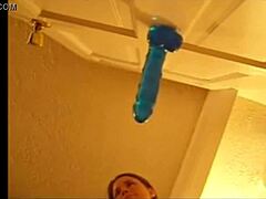 Alexis 19 enjoys solo play with a blue dildo on the door