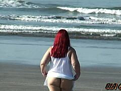 曲線美のある熟女がビーチで美しい日差しの中でアセットを誇示する